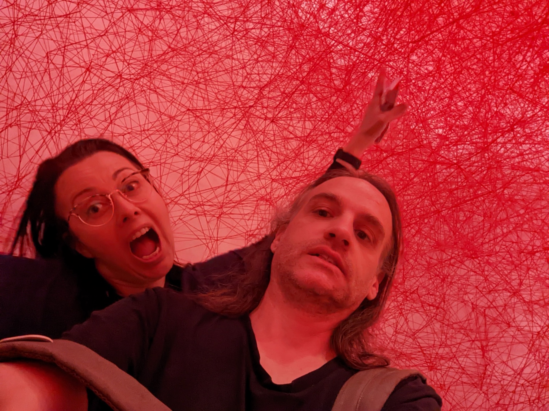 Jackie and Jasper Streit inside a red thread art installation